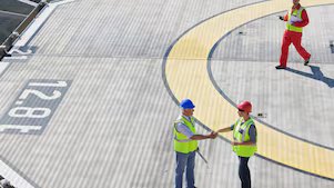 Two Shell employees shake hands as part of a partnership